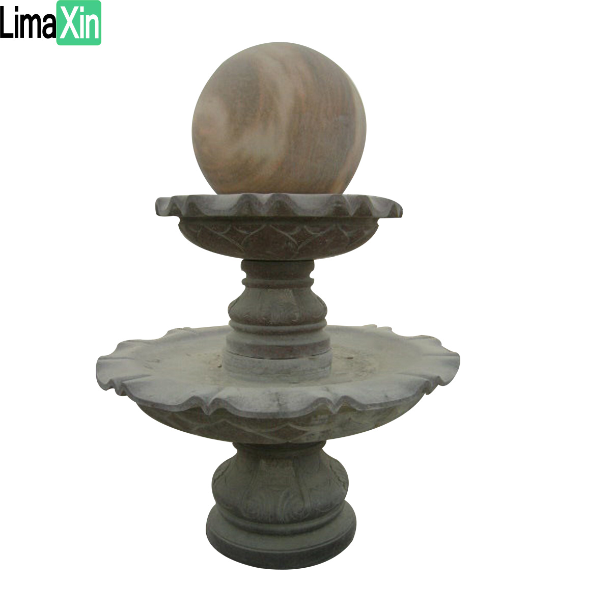 Ball sitting on a black granite fountain — image 1